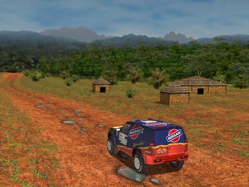 Rear view of a Nissan rally vehicle crossing a rocky dirt track beside thatched buildings and trees